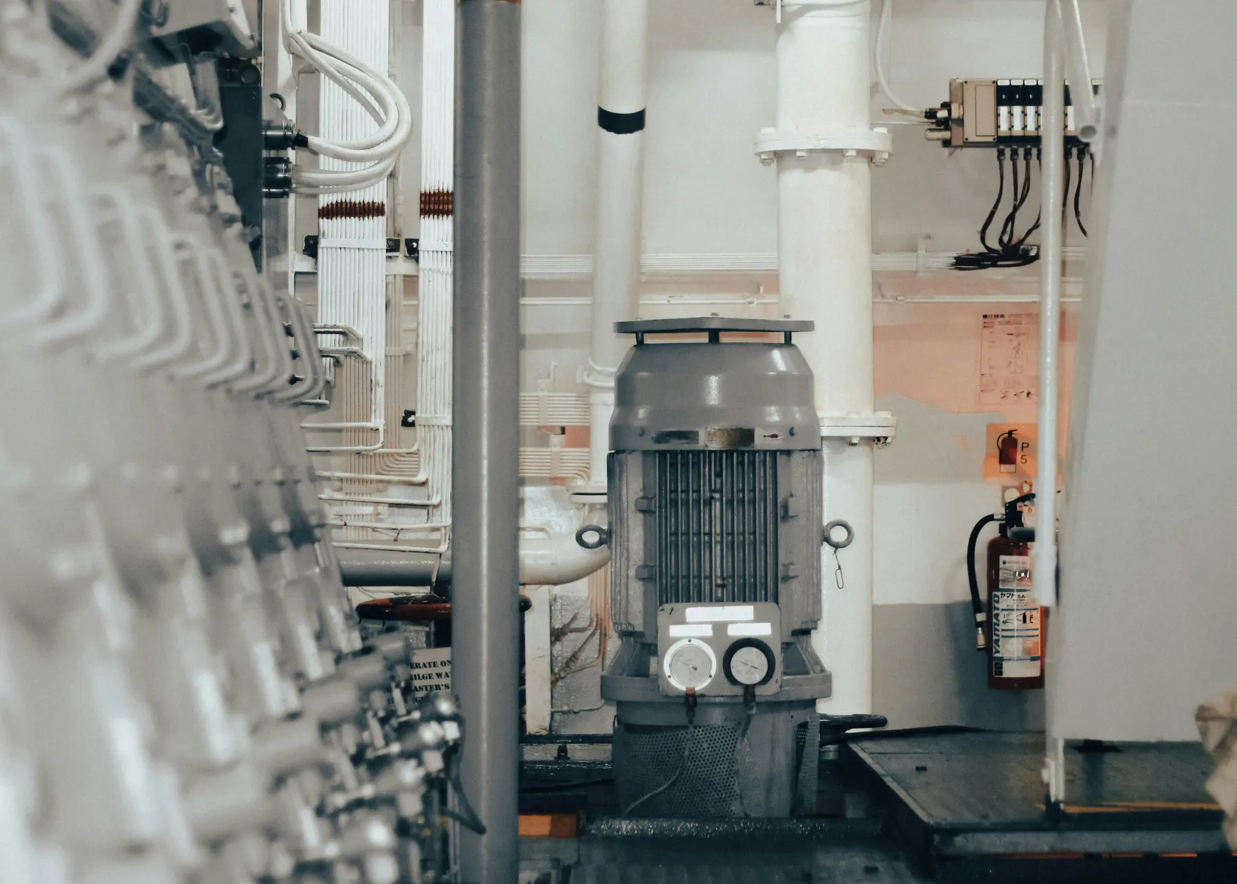 Electric motor and piping in a machinery room